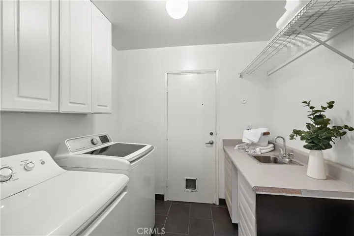 Laundry Room Located off Living Room w/ Sink + Toilet