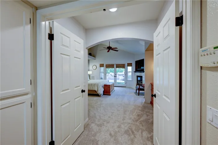 Walk through double doors and an archway to the primary suite.