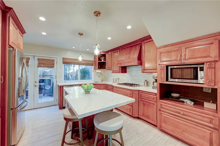 Spacious kitchen island and French doors to one of the the outside patios.