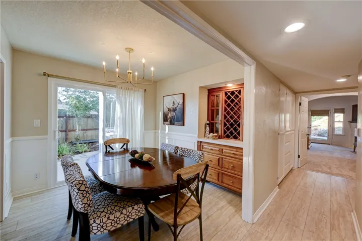 Dining room has custom cabinetry / bar area and a slider to the private side yard.