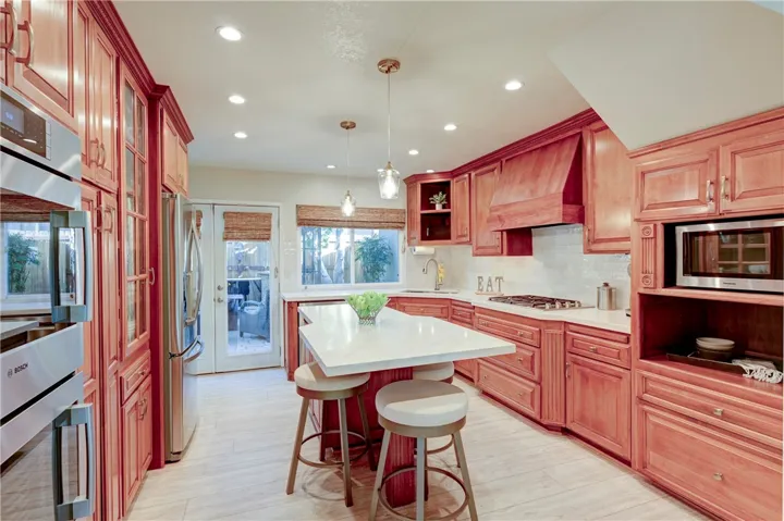Beautiful stainless steel appliances including a WOLF stove and BOSCH ovens.