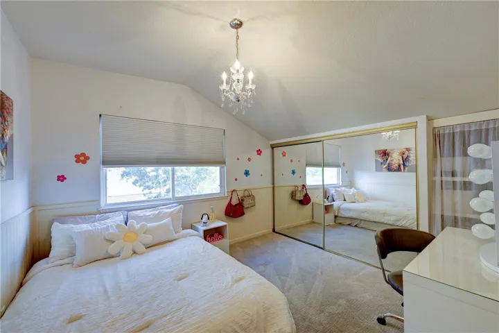 Another upstairs bedroom #4 with mirrored closet doors and vaulted ceiling.