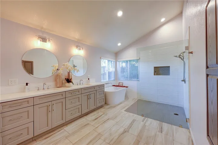 Spacious primary bath with double sinks and large walk in shower.