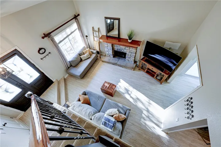 Looking down into the living room from the upstairs landing. Note the updated iron bannister.