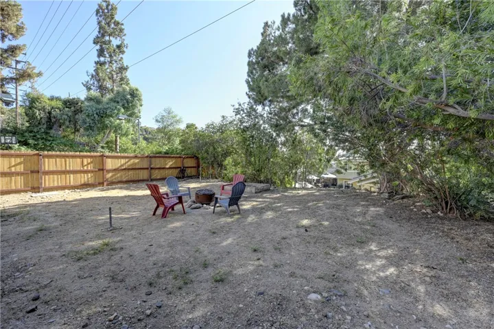 Large flat lot with endless possibilities with a walk way up from the pool.