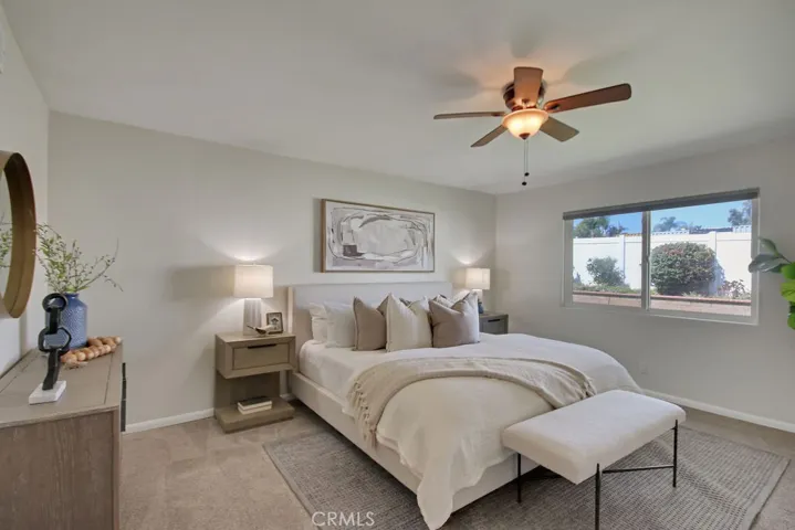 Spacious primary suite tucked at the back of the home, featuring a ceiling fan, peaceful backyard views, and a quiet retreat feel—perfect for rest and relaxation.

