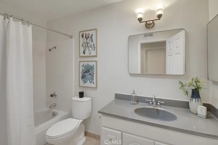 Bright and well-appointed full bathroom with an updated vanity, brushed nickel fixtures, and a classic tub/shower combo—perfect for guests or family use.
