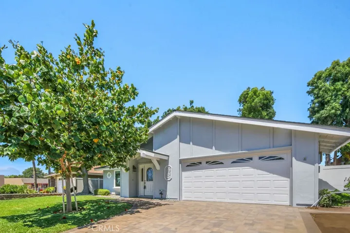 Two car garage with lovely paver driveway.