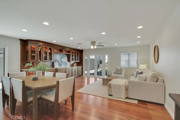 Spacious family room and dining area with stunning built-in cabinetry, recessed lighting, and French doors leading to the covered patio—perfect for entertaining and everyday living.