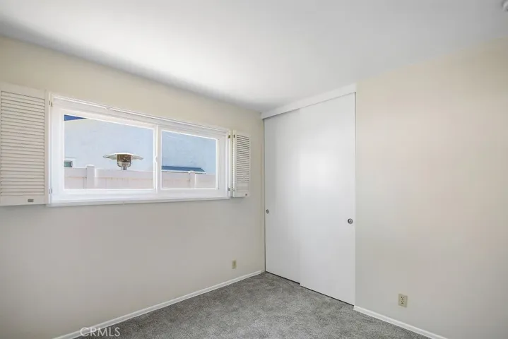 Third bedroom with fresh neutral paint and new carpet.