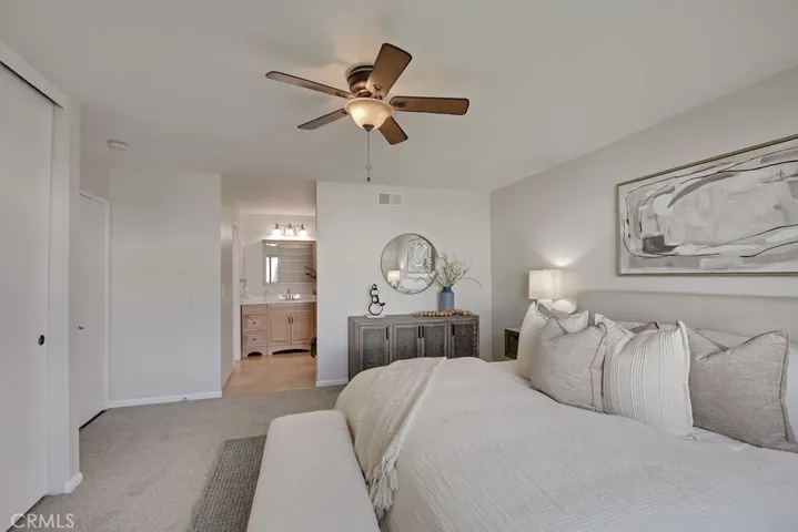 Primary bedroom with dual closets, double-door entry, and serene backyard views—offering both comfort and functionality in a private retreat setting.