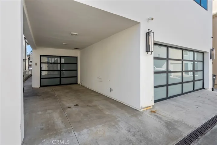 Tandem Carport for Lower Unit, Two Car Garage for Upper Unit