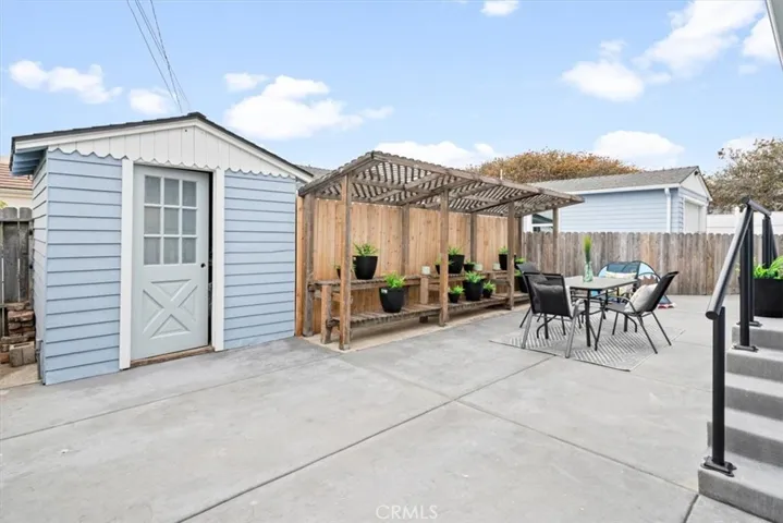 Front house backyard has a shed and plant area.