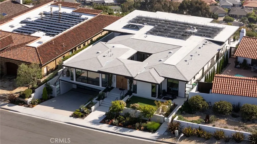 Property features a subterranean, finished three-car garage with epoxy floors, built-in cabinetry and universal EV charging.