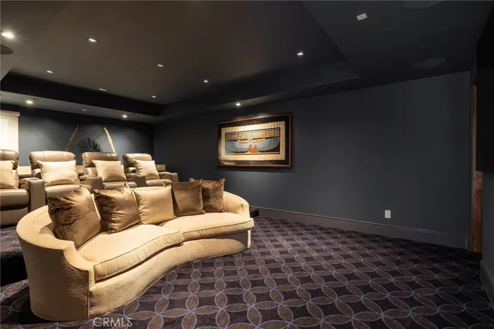 The luxe home theatre features surround sound, comfortable seating, wet bar and adjacent 3/4 bath.
