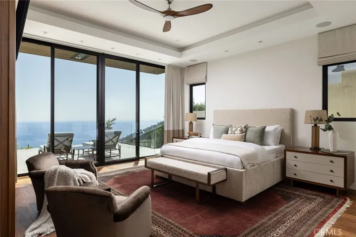The primary suite is a retreat unto itself, with equally impressive views through your private sliding doors.