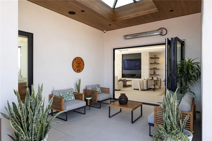 Off the kitchen or great room, you will find additional entertaining or relaxation space on your side patio with stunning skylight treatment, La Cantina door and built-in BBQ space.