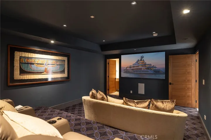 Subterranean, state-of-the-art movie theater with tiered seating and 100” screen is ideal for entertaining.