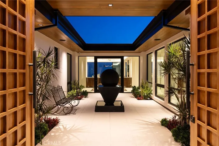 Enclosed entry courtyard with engineered cedar soffit and an artistic center fountain.  Direct entrance to the private casita can be found on the left.