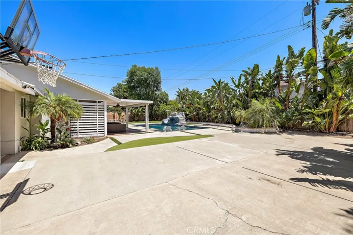 Expansive patio with rare pull-through garage perfect for parking a boat, storing recreational toys, or creating your own private sports/play area.
