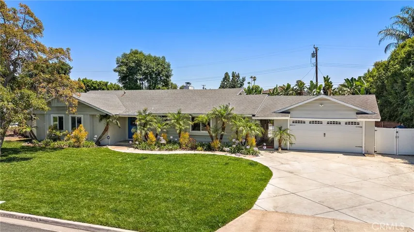 Extra-long driveway offers ample parking and leads to a 2-car garage with convenient pull-through access ideal for boats, trailers, or additional vehicles.
