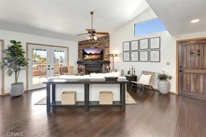 UPSTAIRS, REAR UNIT: Entrance into Living Room with brick fireplace