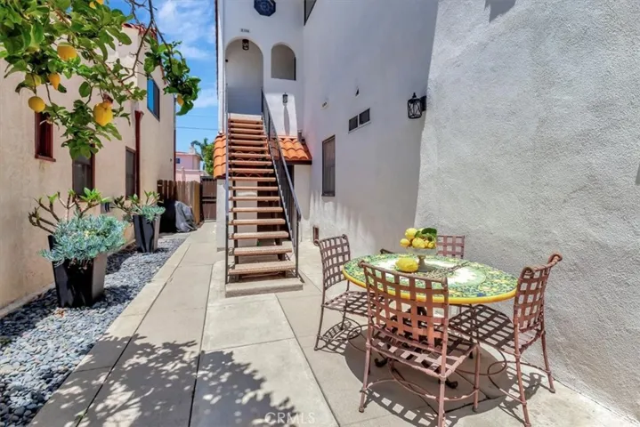 Side private courtyard with stairs to upstairs rear two-bedroom unit.