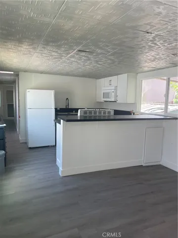Living room into kitchen Fresh paint and baseboards