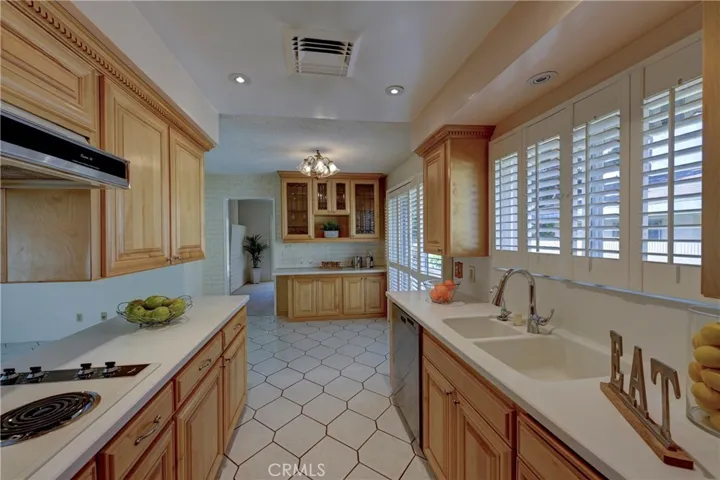 Light and bright kitchen with easy care floors and plantation shutters in both the kitchen and the slider that goes to the side yard.