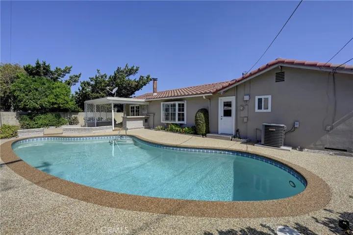Note the white door is the bathroom for easy access from the pool.