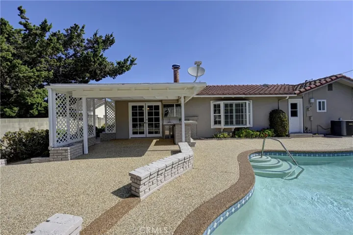 Easy care backyard with relaxing pool.