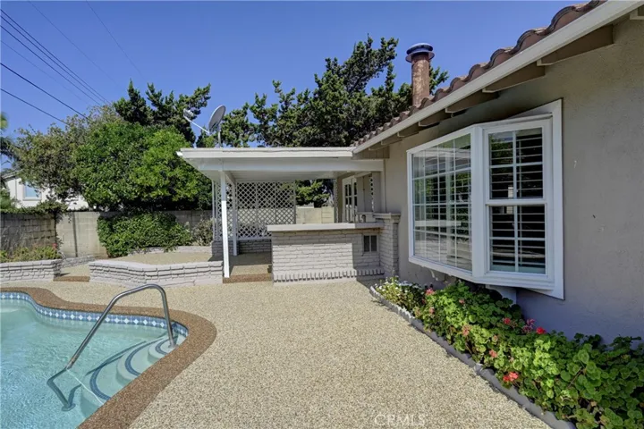 Easy care walkway around the pool and along the one side of the property.