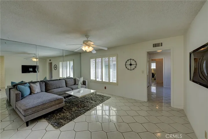 Family room with easy care flooring and lighted ceiling fan.