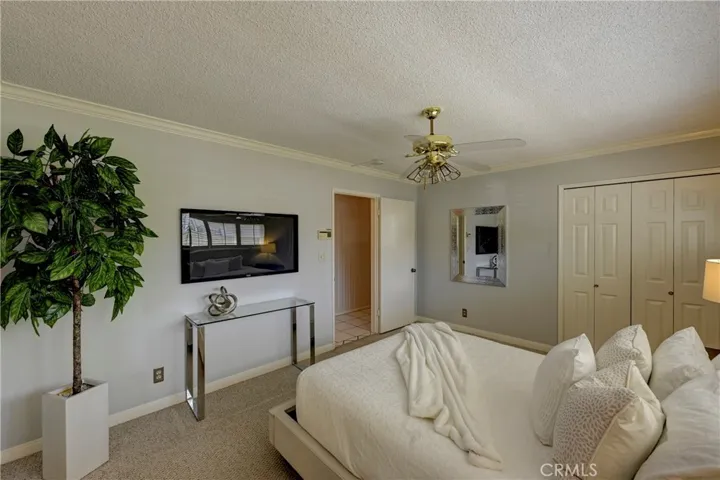 Primary Suite with lighted ceiling fan and large closet.