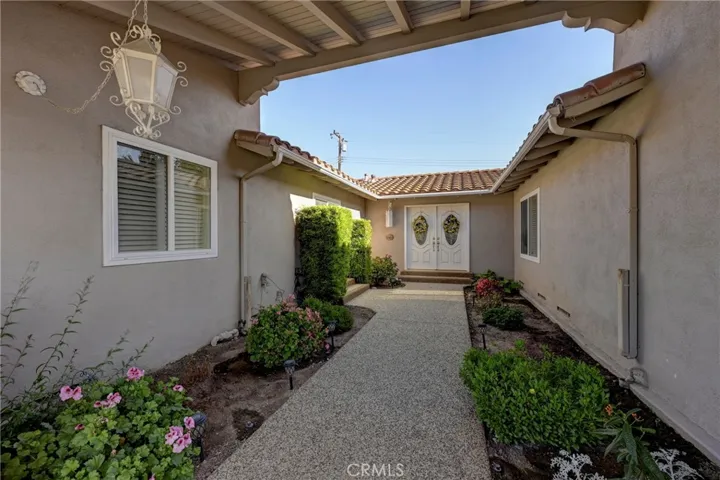 Spacious walkway to the double door entry with glass inserts letting in natural light.