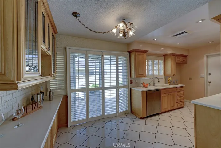 From the family room to the kitchen with extra storage space and a light over an area for a kitchen table.