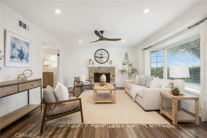 Beautiful living area with bay window and a fireplace.