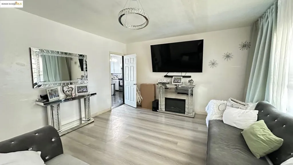 Living room with wood finished floors and a fireplace