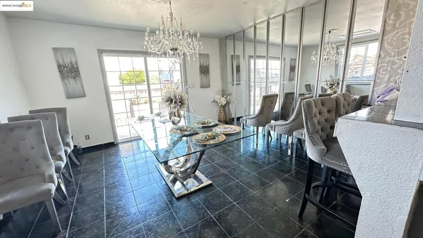 Dining room with a chandelier and a textured ceiling