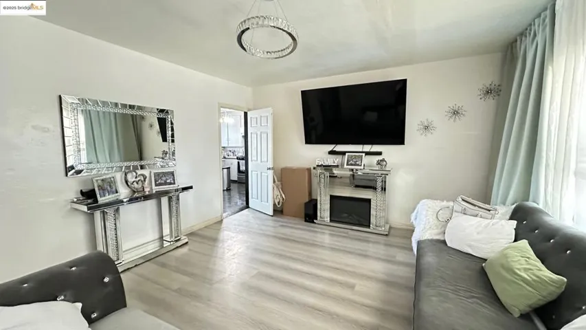 Living room with wood finished floors and a fireplace