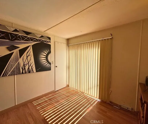 Bedroom 2 with walk-in and sliding door to back yard