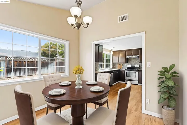 Dining area with light wood-style floors and a chandelier