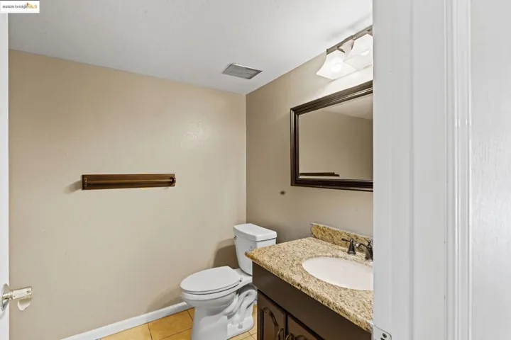 Bathroom with tile patterned floors and vanity