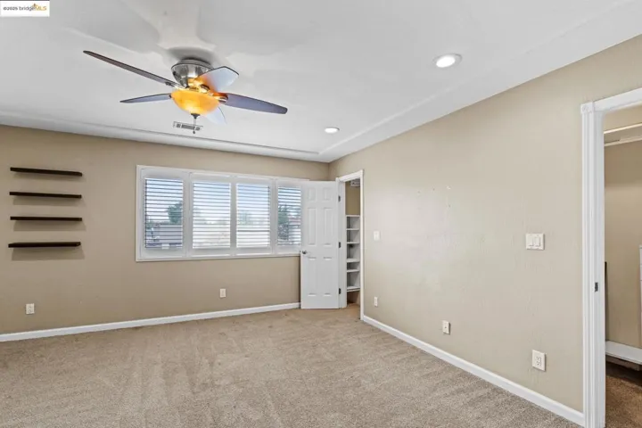 Unfurnished bedroom featuring carpet, recessed lighting, and a ceiling fan