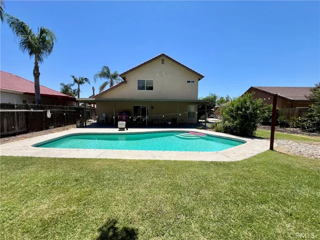 Backyard looking into pool and back of house.