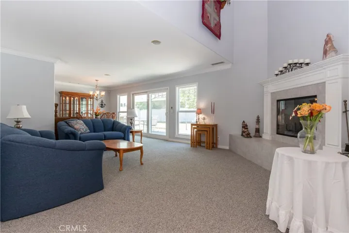 Formal living room with elegant fireplace / could easily be a second family room