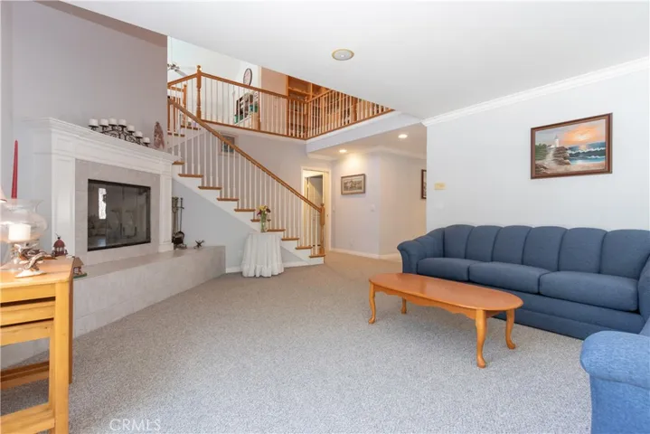 Living room and stairway to the second floor with low-rise steps
