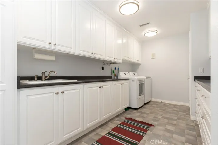 Upstairs laundry room / a second laundry area is downstairs in the RV garage