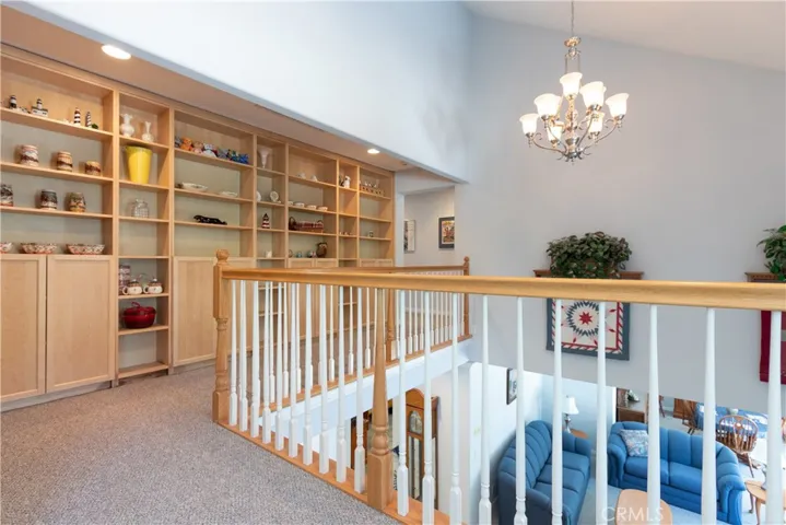 Catwalk from the loft to the upstairs bedrooms, beautiful built-in cabinetry