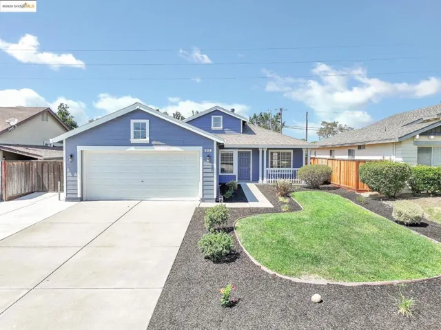 Ranch-style home with concrete driveway, an attached garage, roof with shingles, and covered porch